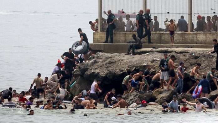 Hundreds of migrants swim across to Ceuta from Morocco
